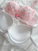 White bra with floral lace details on a white background
