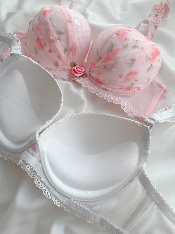 White bra with floral lace details on a white background