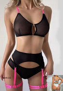 Black lingerie set with pink straps on a plain background