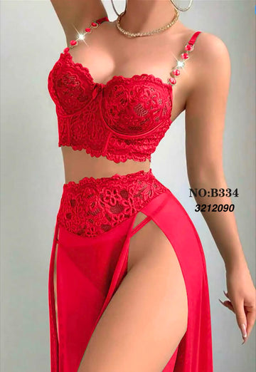 A model wearing a two-piece red lace lingerie set with a high-slit skirt, shown against a plain light gray background. The set includes a red lace bralette with pearl embellishments on the straps and a matching red lace high-waisted brief with a sheer red skirt.