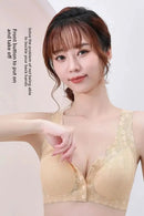 Woman wearing a beige bralette against a plain background